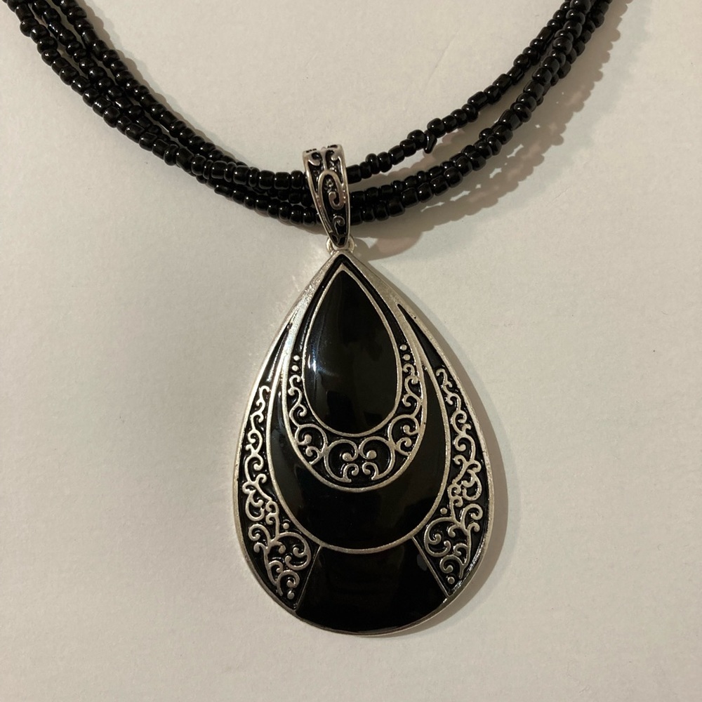 Black beaded necklace with black and silver pendant